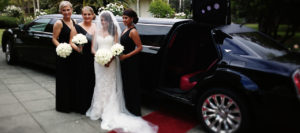 Bride in front of limousine